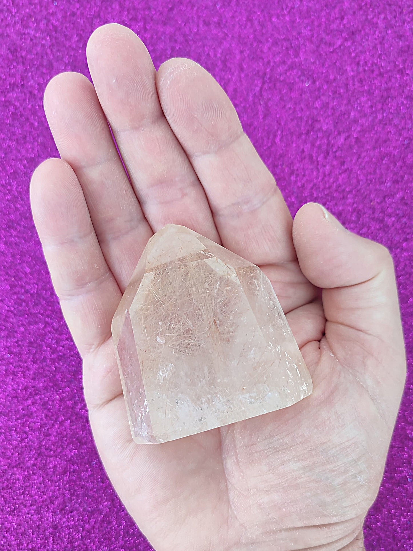 Cuarzo cristal con rutilo blanco y dorado y trazas de hematite rojo - Imagen de cuarzo con inclusiones de rutilo dorado y hematite, ideal para coleccionistas y gemoterapia.